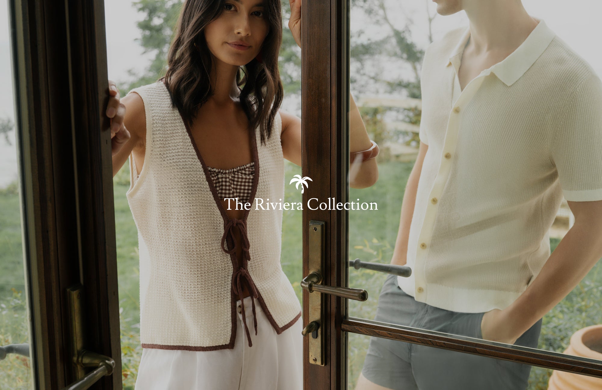 Two people standing in a doorway with 'The Riviera Collection' logo.